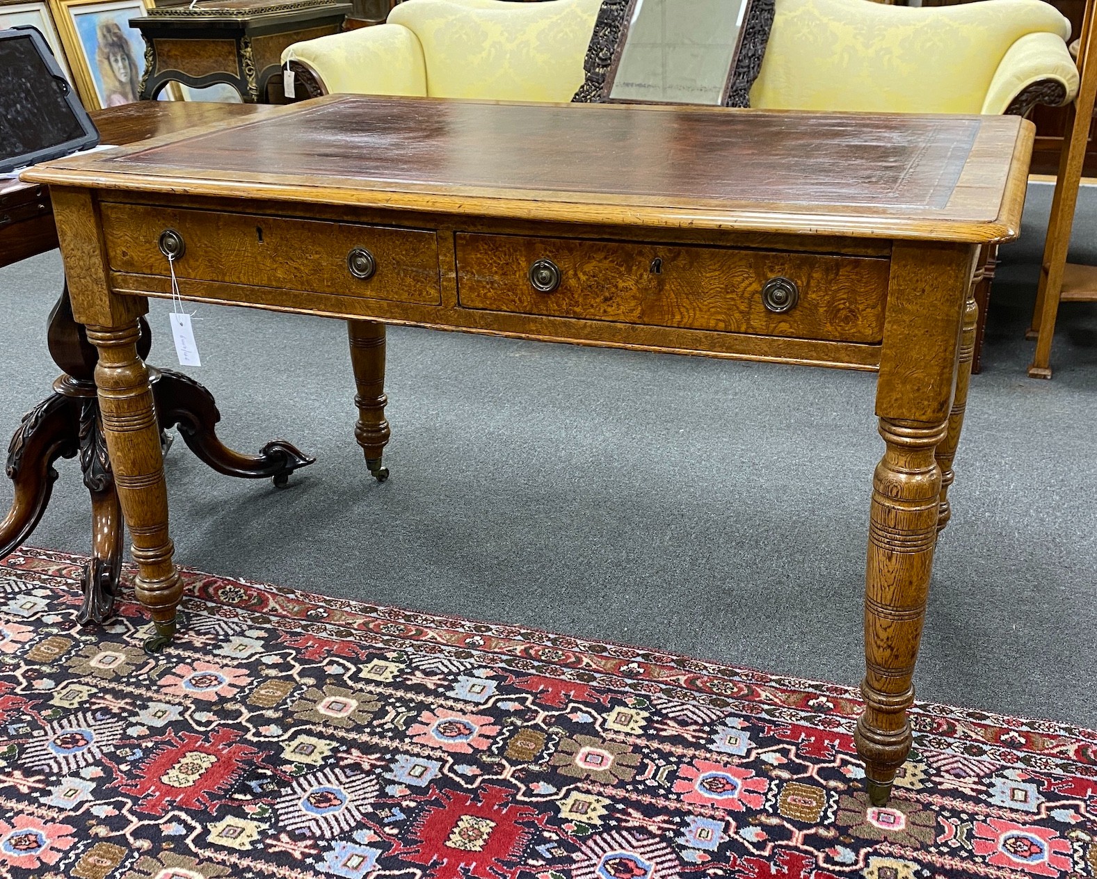 A Victorian oak and pollard oak writing table fitted two drawers opposed by dummy drawers width 120cm, depth 78cm, height 76cm.